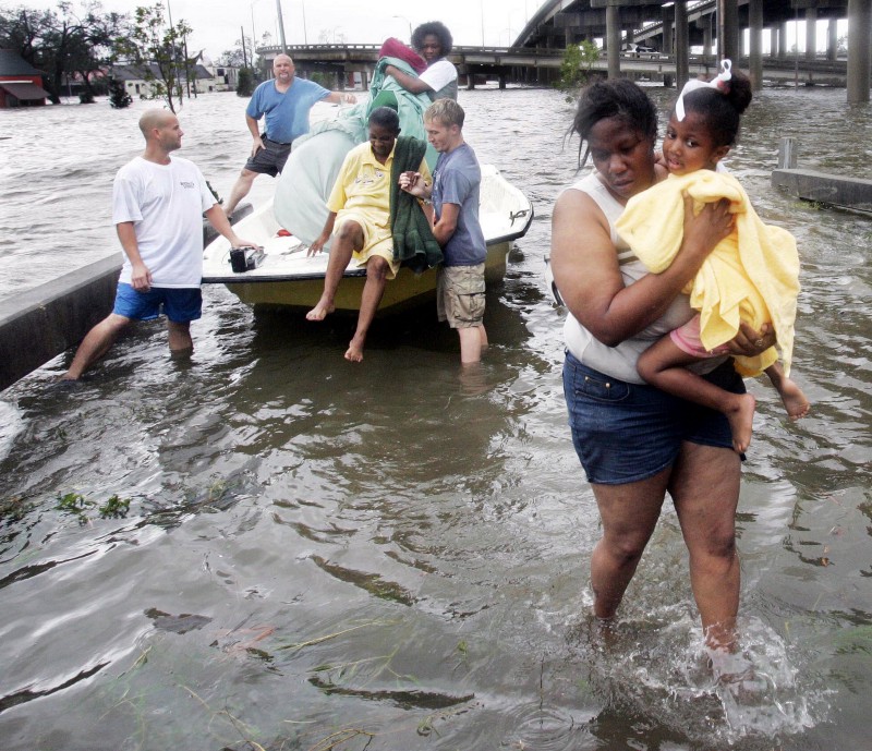 people walking in water in Hurricane Katrina