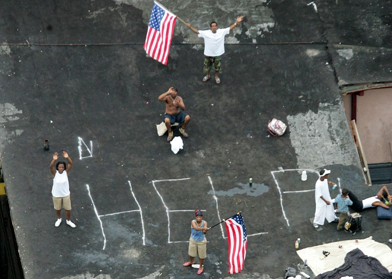 Hurricane Katrina-people waving flags with "help" written