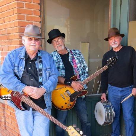 three musicians posing with their instruments