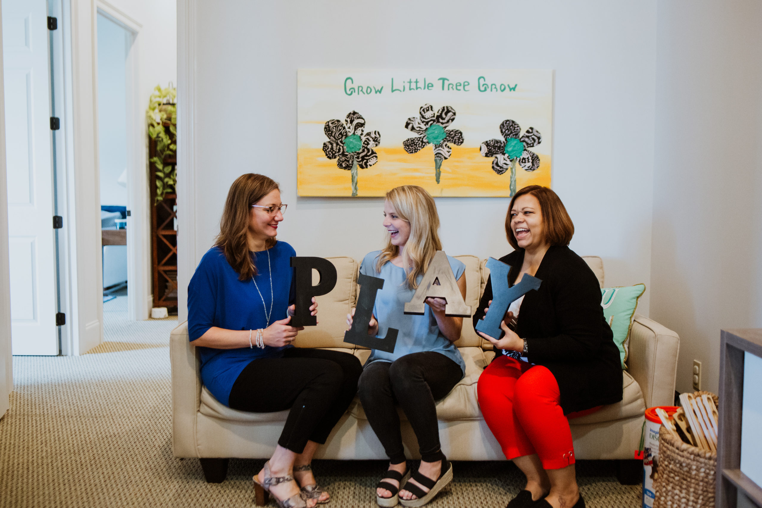 3 women sitting on couch